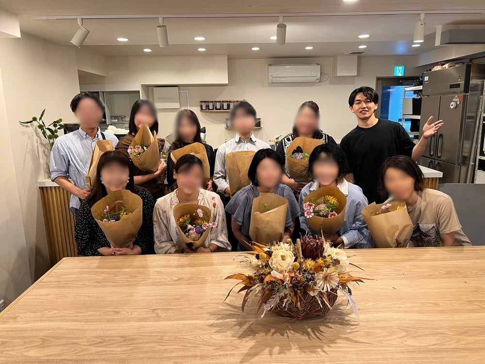 花を囲むBouquetメンバーの交流会（顔にモザイク処理済み）